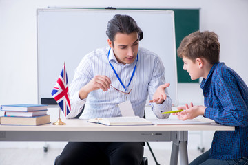 Wall Mural - Male english teacher and boy in the classroom