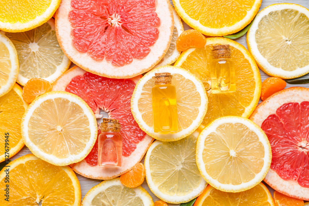 Bottles with essential oils on citrus fruits slices