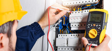 Electrician Installing Electric Cable Wires Of Fuse Switch Box.