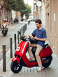 © Aitor - Biker boy with black helmet sitting on red motorcycle