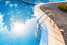 Steps Into The Pool With Handrails In Water Reflex Sun. For Tourists.