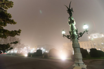 Wall Mural - Angel sculpture and Vienna Museum Quarter fog and evening