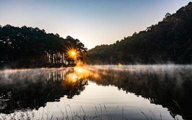 Wall Mural - The atmosphere of the morning sunrise among the lakes in the beautiful forest at Pang Ung, Mae Hong Son in Thailand.