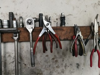 Car repair tool kit on plaster background and black stains