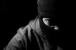 © Towfiqu Barbhuiya  - angry man in a balaclava on a dark background.