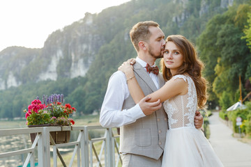 Couple of newlyweds walking in the background of mountains