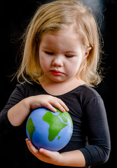 Wall Mural - Close up little girl holds planet in her hands. Ecology concept