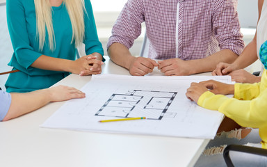 Wall Mural - business, architecture and people concept - close up of architects team working with blueprint at office