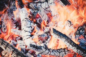 The burning charcoal. Hot fire close-up. Burning wood close-up. View of the fireplace inside.