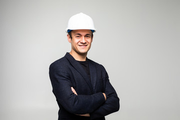 Wall Mural - Portrait of happy young business man in helmet isolated on white background