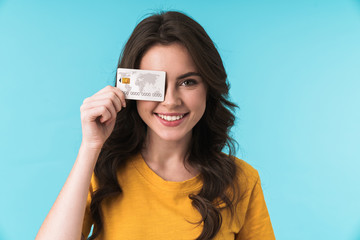 Sticker - Positive smiling young pretty woman holding credit card.