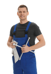 Wall Mural - Portrait of professional auto mechanic with lug wrench and rag on white background