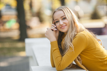 Young attractive woman outdoors. Pretty lady on urban background. Female close up portrait.