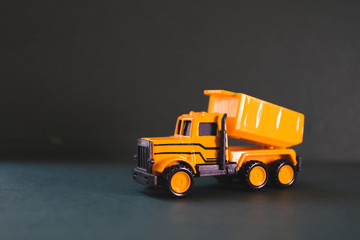 Closeup group yellow truck vehicle on dark background