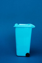 Wall Mural - toy trash can on blue background with copy space