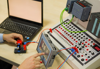 an operator is taking plc course for industry 4.0 preparation in an automation education center. eng