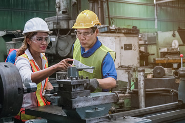 Wall Mural - Man and woman engineer industry worker wearing hard hat in factory,