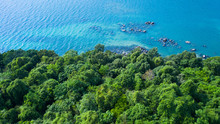 Aerial Drone View Of Rocky Shore With Turquoise Sea Water And Green Trees