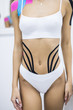 © F8  \ Suport Ukraine - Sexy body with kinesio tape on the abdomen of young girl. Sport tratment.