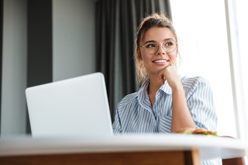 Poster - Image of happy nice woman working with laptop and smiling