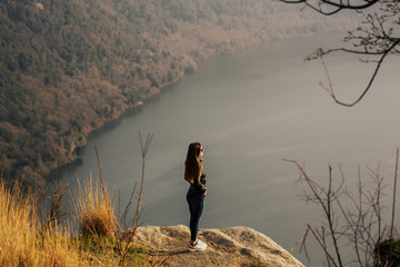 Wall Mural - Girl with the scenic sight on Albano lake, in the province of Rome, Lazio, central Italy. Woman enjoying view of majestic mountain lake. 