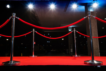 red carpet with barriers and red ropes.