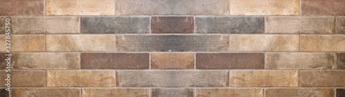 Fotografía Brown gray natural stone tiles masonry wall texture background banner