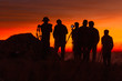 © Jakapan - Silhouette of group tourists take a photo on a hill at sunset