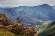 Leinwandbild Motiv Bike trip. A man with a bicycle on a mountain pass
