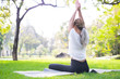 © anon - Portrait of young woman practicing yoga in garden.female happiness. blurred background.Healthy lifestyle and relaxation concept.Young Asian Girl doing yoga in the park