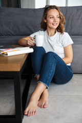 Sticker - Image of happy attractive woman smiling and drinking coffee