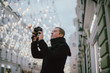 © Anna - A man with a camera photographs the street of the old city in winter