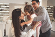 © Надин Стокер - Happy family is playing with daughter. Dad throws up the baby