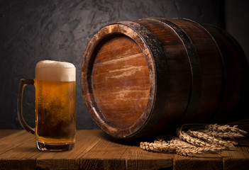 Wall Mural - Glass beer with hop cones and wheat ears on dark wooden background. Beer brewery concept. Beer background. top view with copy space