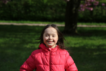 Wall Mural - Cute smiling girl in the park