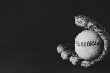 Canvas Print - Isolated baseball and glove on black background.