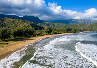 Wall Mural - Aerial panoramic image at sunrise off the coast over Hanalei Bay and Waioli beach park on Hawaiian island of Kauai