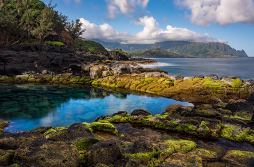 Long exposure of the calm waters of Queen's Bath, a rock pool off Princeville on north shore of Kauai