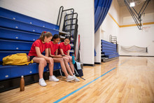 Junior High Girl Students Using Smart Phone In Gymnasium