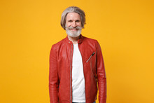 Smiling Elderly Gray-haired Mustache Bearded Man In Red Leather Jacket Posing Isolated On Yellow Orange Wall Background Studio Portrait. People Lifestyle Concept. Mock Up Copy Space. Looking Camera.