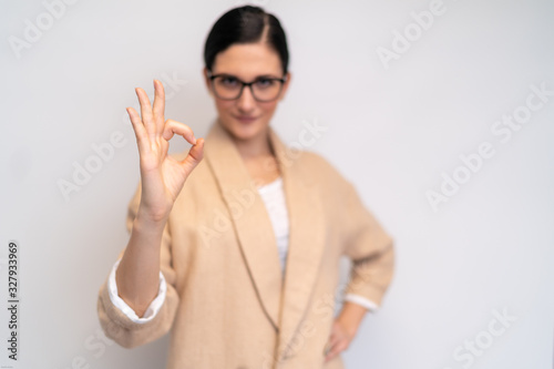 Fotomural Sympathic young woman with glasses showing everything alright