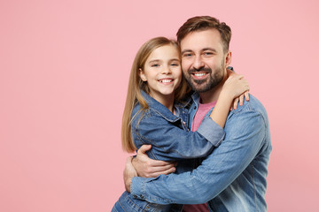 Wall Mural - Pretty bearded man in casual clothes have fun with cute child baby girl. Father little kid daughter isolated on pastel pink background in studio. Love family parenthood childhood concept. Hugging.