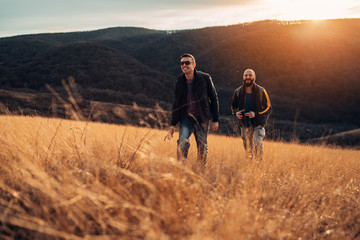 two happy friends hiking in the hills