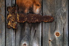 Old Rusty Door Hinge On Wooden Door 
