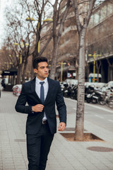 Wall Mural - young boy walking with blue suit in city