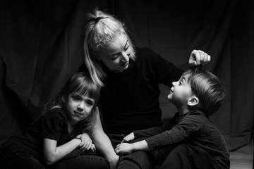 caucasian Family Portrait in Black and White. mom daughter and son. caucasian family with two children