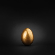 Golden Painted Egg On Black Background