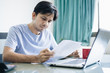 Young Asian Man in working with financial documents 