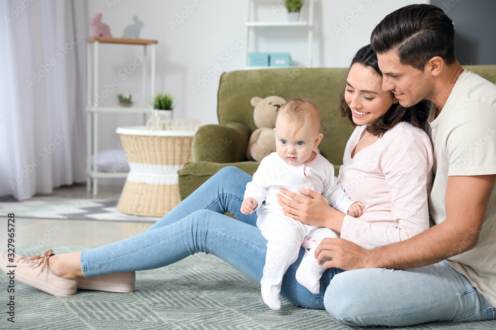 Cute baby with parents at home