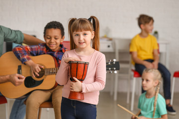 Wall Mural - Cute little girl at music school